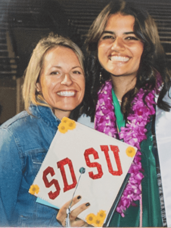 In the photo, Ila Pecus and her mother Lisa stand side by side, smiling at the camera on Ila’s high school graduation day. (Courtesy photo)